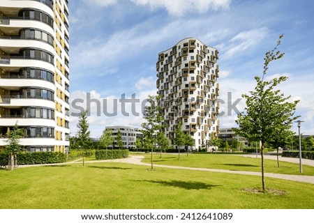 Residential area in the city, modern sustainable high-rise apartment buildings in a green environment Royalty-Free Stock Photo #2412641089