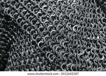 Chain mail close up photo with selective focus. Medieval knight torso armor made of linked iron rings
