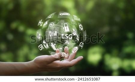 Hand protecting the earth with icons around the world.Illustration of green environment business or green investment concept.Virtual screen with icons on green background