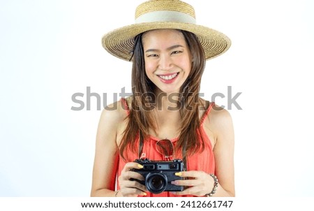Portrait Asian beautiful woman wearing casual clothes, hat, holding camera, standing on isolated white background cut out with copy space, happily smiling. Travel, Summer, Vacation Concept