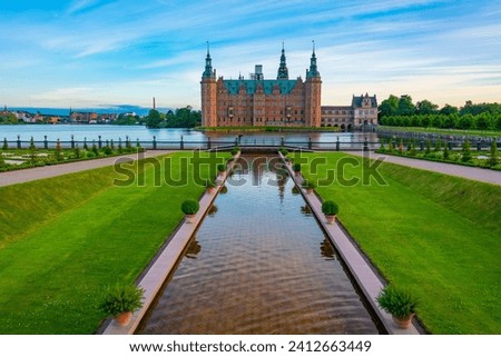 Sunset view of gardens of Frederiksborg Slot palace in Denmark.