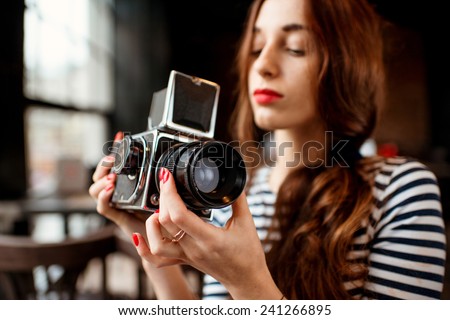 Woman holding old 6x6 frame photo camera