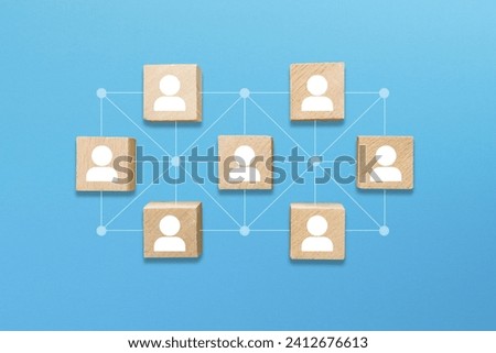 Business network connection. Teamwork, network and community concept. Wooden blocks with businessman icon on blue background.