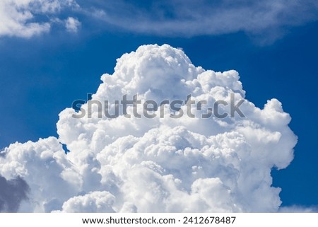 Closeup of Billowy cumulus clouds. Wispy clouds, deep blue sky in background. 
 Royalty-Free Stock Photo #2412678487