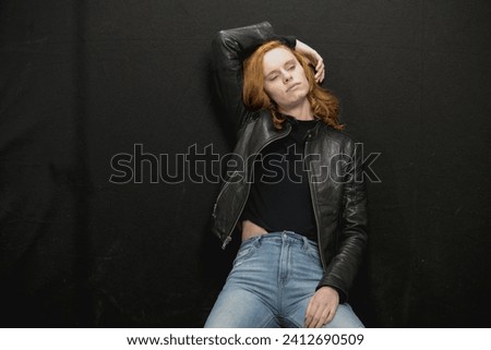 Young Woman with Red Hair and Black Leather Jacket