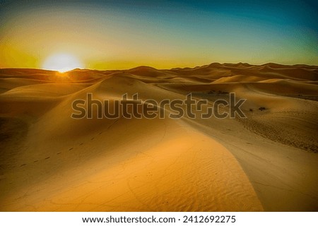 Sahara Desert sand dunes background. Popular travel destination, Erg Chebbi, Sahara Desert, Morocco.Erg Chebbi Royalty-Free Stock Photo #2412692275