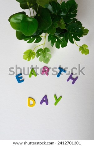earth day in colorful letters on a pink marble background