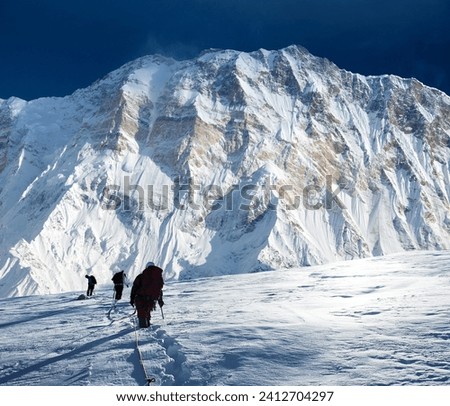 montage of hikers on glacier and mount Annapurna 1 from Mt Annapurna south base camp, Nepal Himalayas mountains Royalty-Free Stock Photo #2412704297