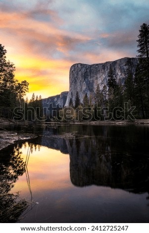 A fine art landscape photography image of El Capitan in Yosemite National Park reflected in a calm river during a vibrant, colourful and dynamic Spring Sunset
