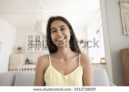 Head shot portrait attractive young woman staring at camera, using videocall application for remote, distancing communication with family or friend. Virtual meeting event at home, modern technologies Royalty-Free Stock Photo #2412728039