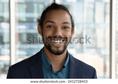 Young businessman portrait. Profile picture of smiling successful black employee pass job interview online speak by video call. African male professional consultant look at camera glad to help client