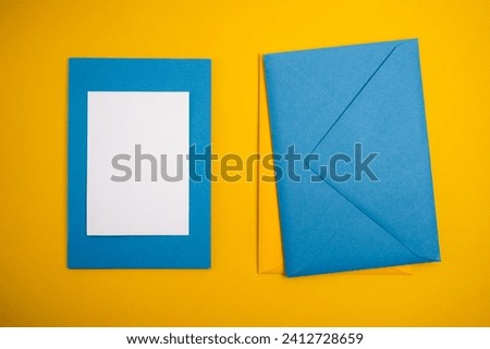 Paper yellow and blue envelopes on a light background. New mail, write a message. Send and receive mail. Postal delivery service. Empty envelope, empty space. Envelope close-up 