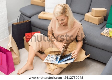 Woman Looking At Photo Album Or Photobook