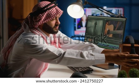 Audio editor wearing headphones while editing project in post production, upgrading sound quality. Man using professional software to make changes to footage on PC workstation