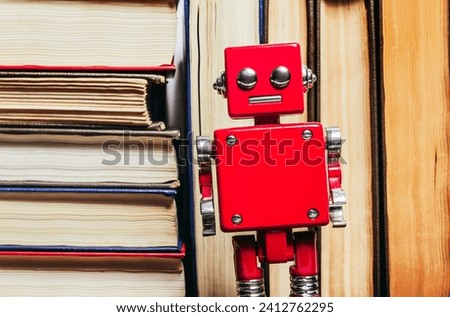 Photo of old antique books stack and row with robot toy, close up view.