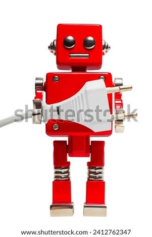 Isolated photo of red toy robot holding euro electric plug on white background.