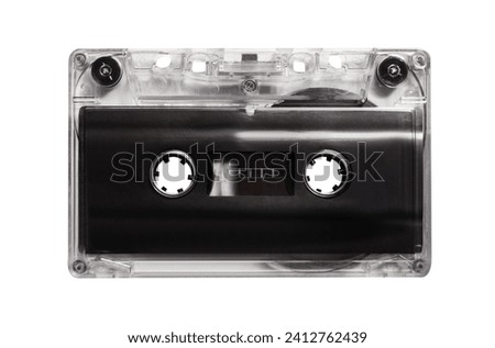 Isolated photo of old fashioned, transparent and black colored audio tape cassette on white background.