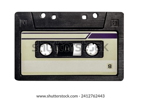 Isolated photo of old fashioned, black colored audio tape cassette on white background.