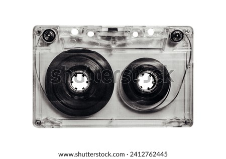 Isolated photo of old fashioned, transparent audio tape cassette on white background.