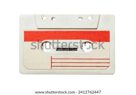 Isolated photo of old fashioned, white colored with red stripes audio tape cassette on white background.