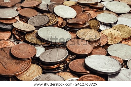 Photo of various european coins pile, side view.
