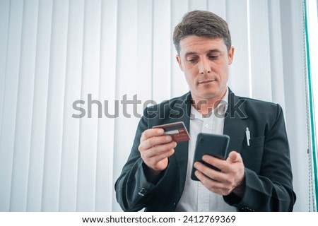 Businessman holds a credit card,unlocking opportunities with digital transactions and savvy financial choices
