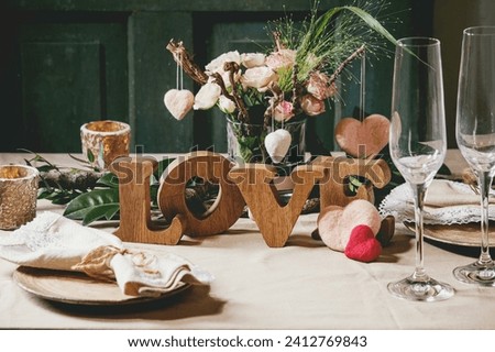 valentine's day table setting with wooden letters love Royalty-Free Stock Photo #2412769843