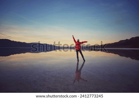 Beautiful sunset at the flooded Badwater Basin in Death Valley National Park, USA Royalty-Free Stock Photo #2412773245
