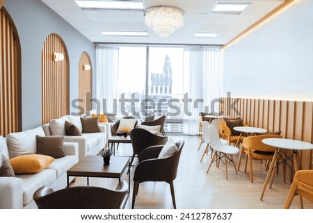 Empty stylish and modern office interior with skyscrapers view decorated with table, chair, botany decoration, elegant accessory. Living room. Modern interior. Creative design. Day light. Ornamented. Royalty-Free Stock Photo #2412787637