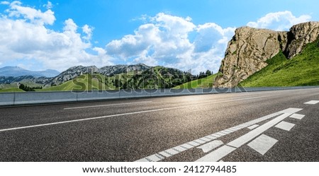 Asphalt highway road and mountain nature landscape under blue sky