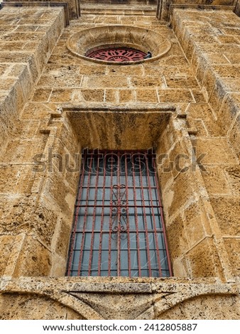 Latticed windows in a stone cathedral wall