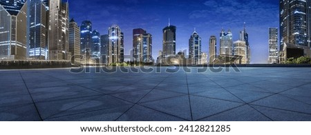 Empty square floors and modern city buildings at night in Shanghai