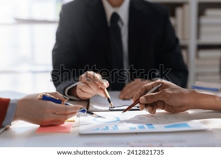 Business team analyzing financial documents. Meeting of businesswomen pointing at graph.