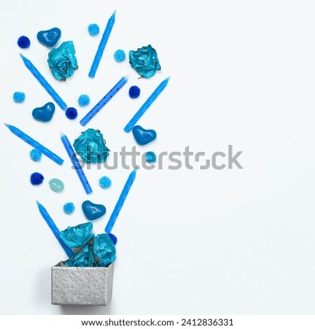 The image depicts a group of blue objects, with a focus on the color turquoise. The objects appear to be related to art.