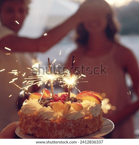 The image is of a person blowing out candles on a birthday cake.