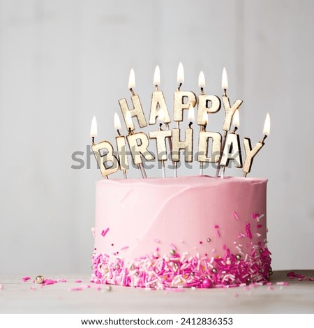 The image is of a pink birthday cake with candles.