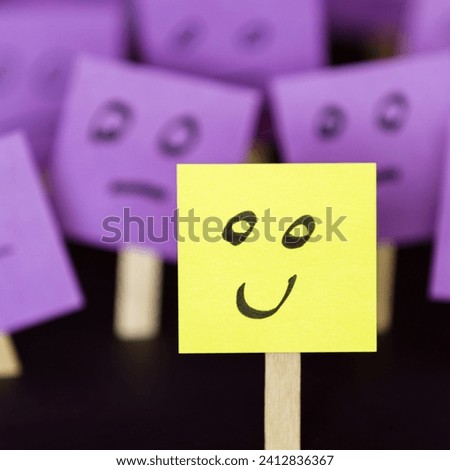 The image is a yellow sticker with a face on it, resembling a post-it note.