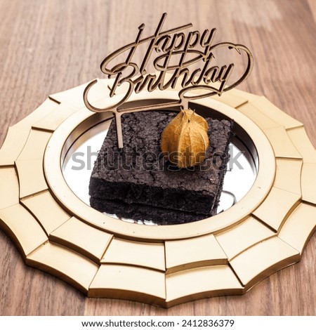 The image is a birthday cake with a message on it. It is a dessert made of chocolate and is typically served indoors..