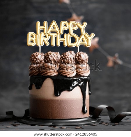 The image is a chocolate cake with nuts on top. The cake has the words "HAPPY BIRTHDAY" written on it. It is a dessert and snack, and falls under the categories of food, baked goods, chocolate, and ca