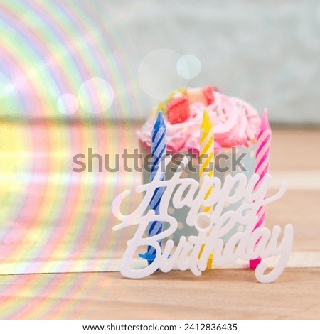 The image is a birthday cake with a candle on top. The cake appears to be pink, and it is decorated with food coloring.b