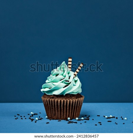 The image is a cupcake with a blue background.