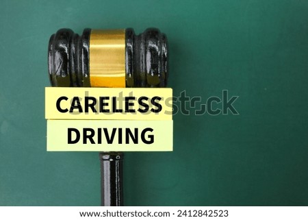 judge's gavel and colored paper with the word careless driving. the concept of reckless driving. Royalty-Free Stock Photo #2412842523