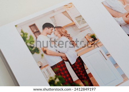 The pages of a photo book with color photos of a pregnant blonde and a man. Beautiful and convenient storage of photos. Pregnancy photo shoot as a keepsake. Professional photo printing.