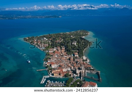 Aerial view on Sirmione sul Garda. Italy, Lombardy. Panoramic view at high altitude.  Rocca Scaligera Castle in Sirmione. Aerial photography with drone