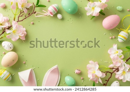 Transport your audience to Easter wonderland with this top view photo showcasing eggs, adorable bunny ears, apple blossoms, sprinkles, pastel green canvas, providing space for your text or advertising