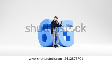 Young woman with smartphone standing near big 6G sign over white copy space background. Concept of internet connection and communication