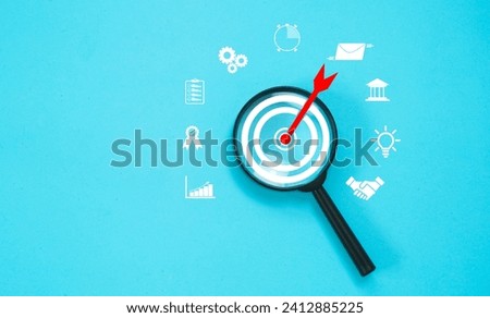 Magnifier focus on business target, with business icon, concept of Setting business goals and tools for doing business.