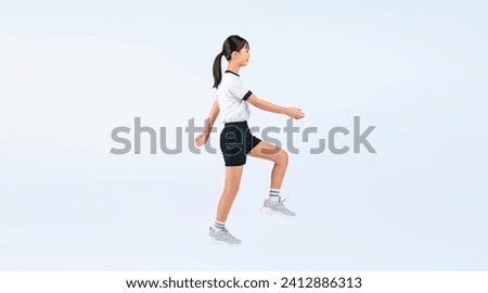 A full-body photo of an elementary school girl walking wearing gym clothes.