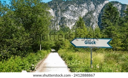 picture shows a signpost and a sign pointing towards luck in german. Royalty-Free Stock Photo #2412888867
