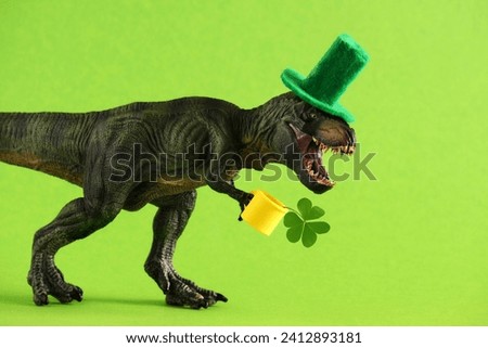 Two green dinosaurs in green hats with beer and clover leaf celebrating St. Patrick's day. Unusual festive card.